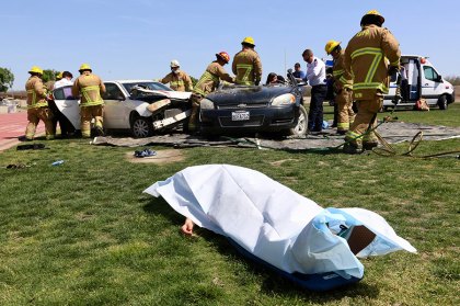 Lemoore High School and Every 15 Minutes, a lesson that keeps on teaching A victim is beneath a tarp as firefighters scramble to save other victims.